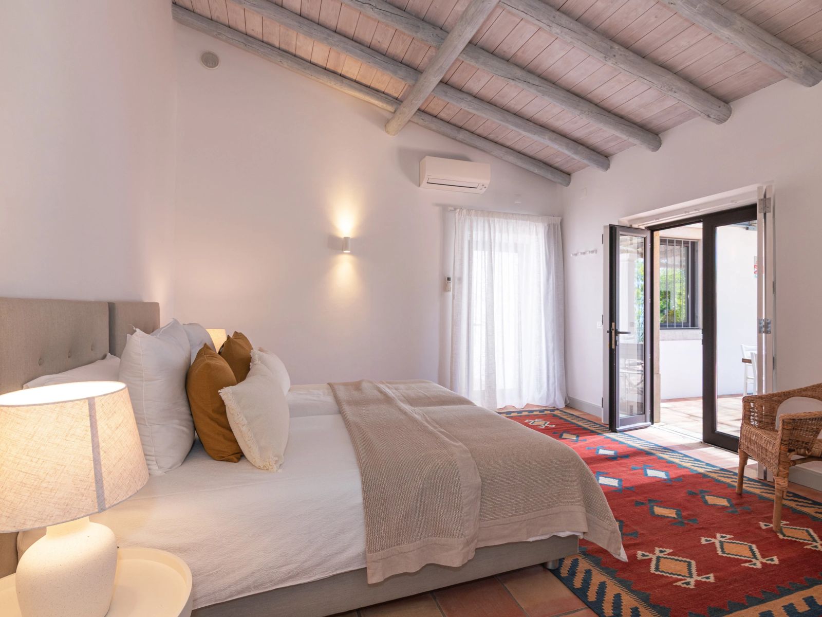 A bedroom at the villa with exposed beam ceiling