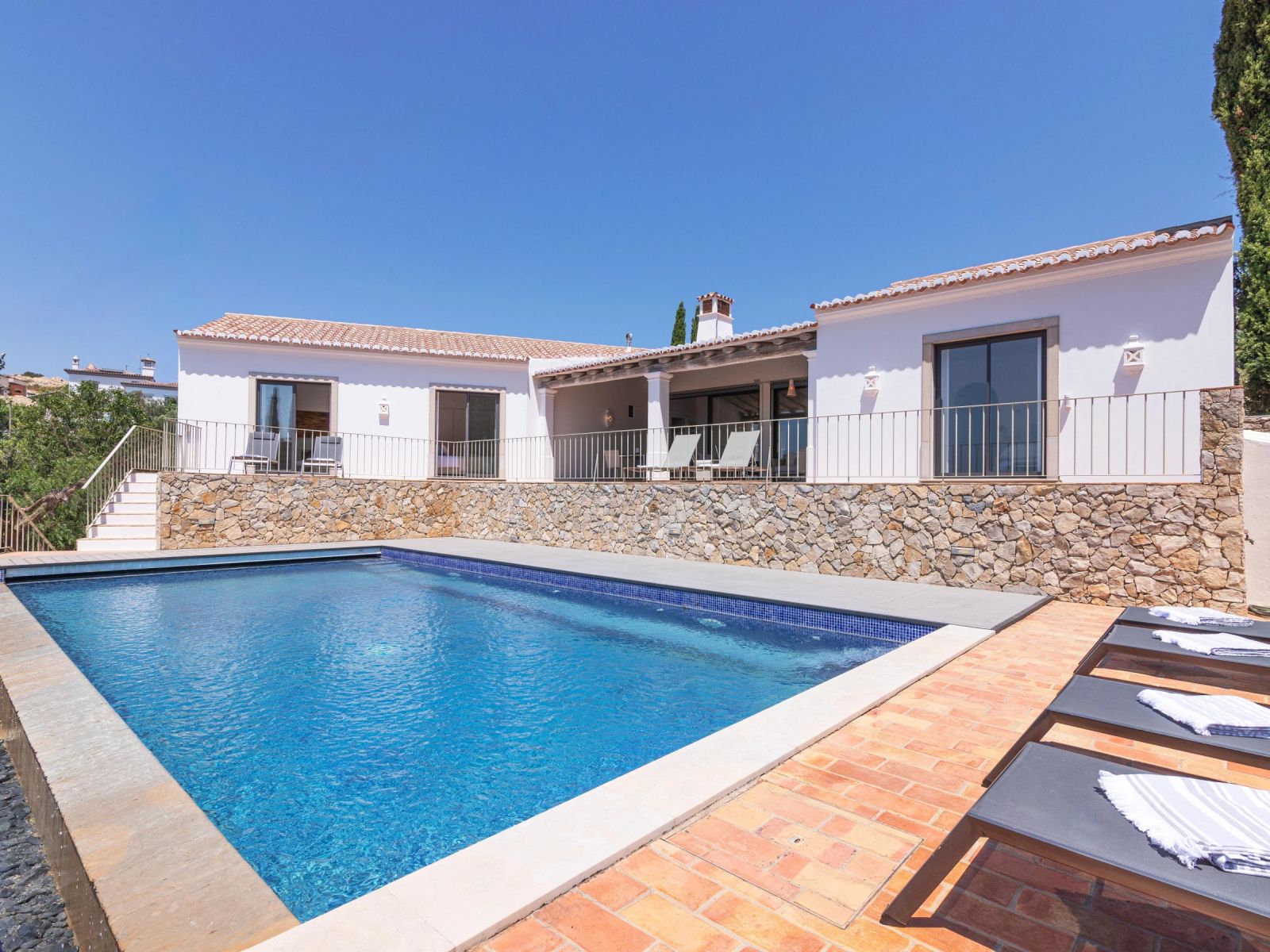 The full villa exterior and pool