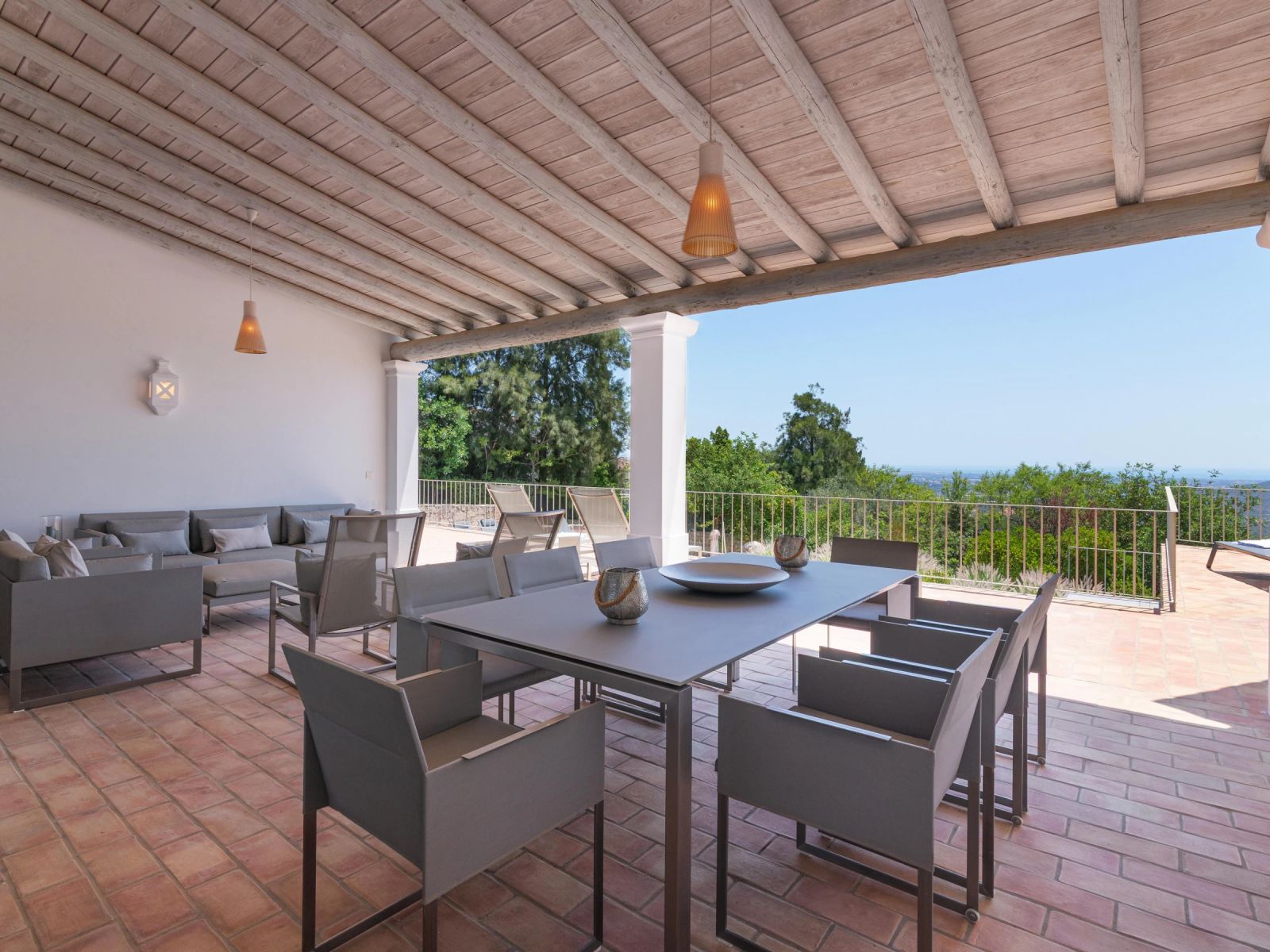 The villa's covered terrace and garden